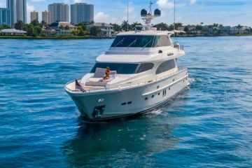 Woman on the bow of this Palm Beach yacht rental.