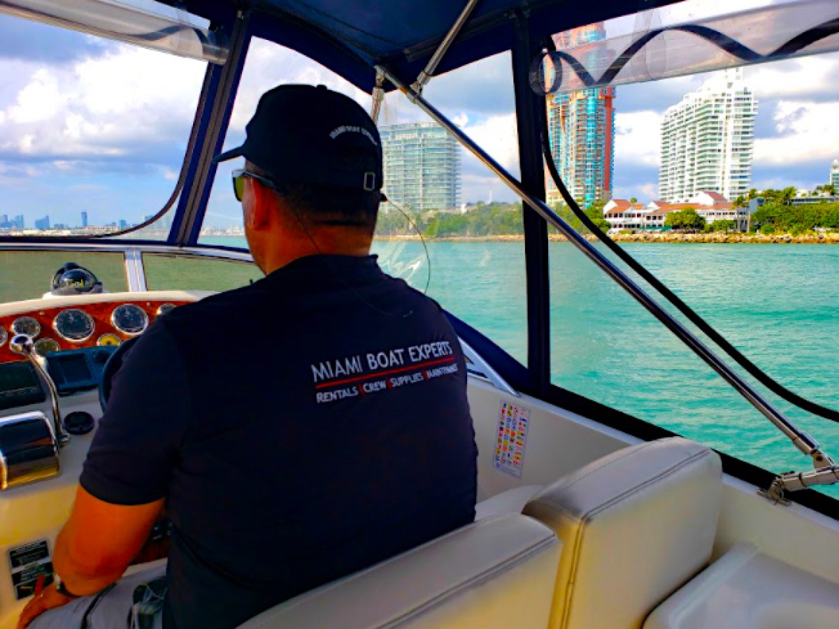 Captain driving this boat for rent in Miami.